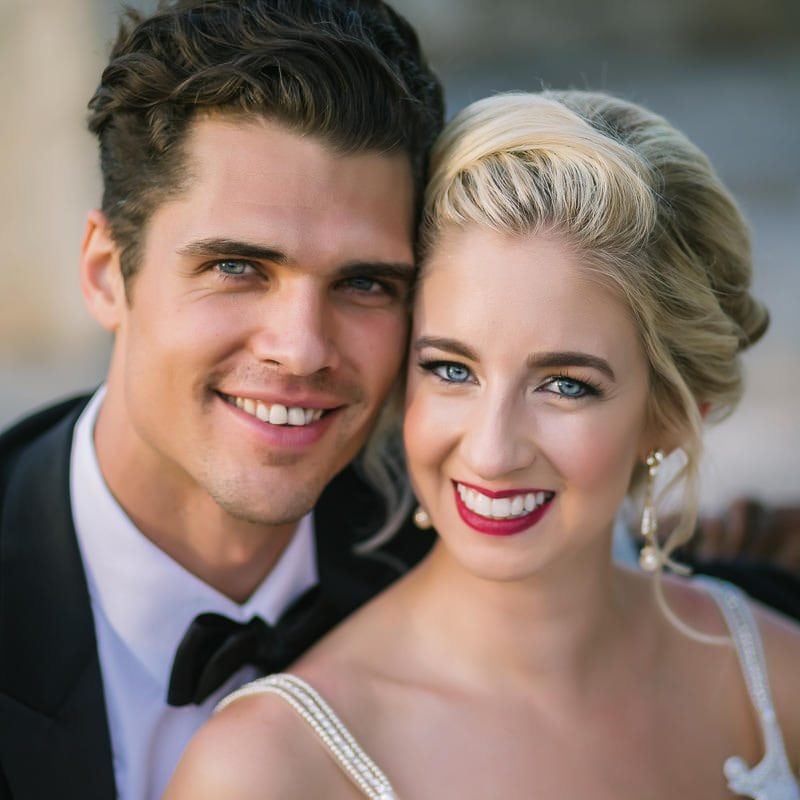bride and groom smile for camera at their wedding