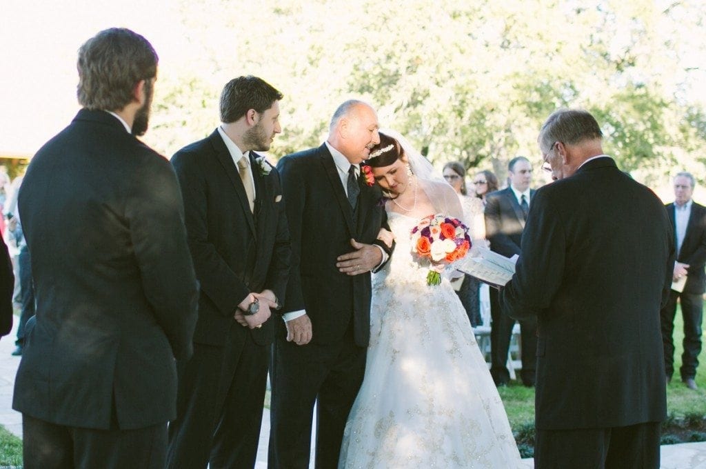 Father of the bride hugs daughter before giving her away at her wedding.