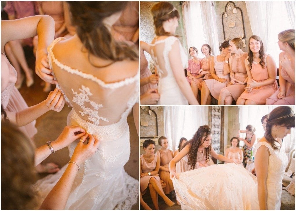 The bride puts her wedding gown on before her wedding at Olde Dobbin Station.  