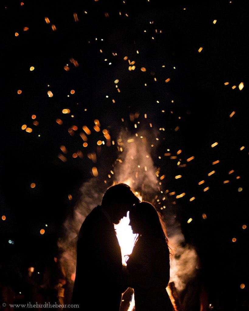 Bride and groom stand in front of a bonfire for an awesome photo at their game of thrones themed wedding