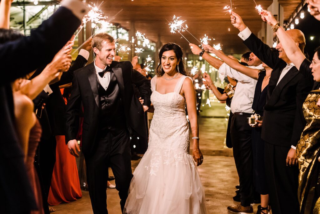 Bride and groom walking through sparklers as part of a Lakeway Resort wedding