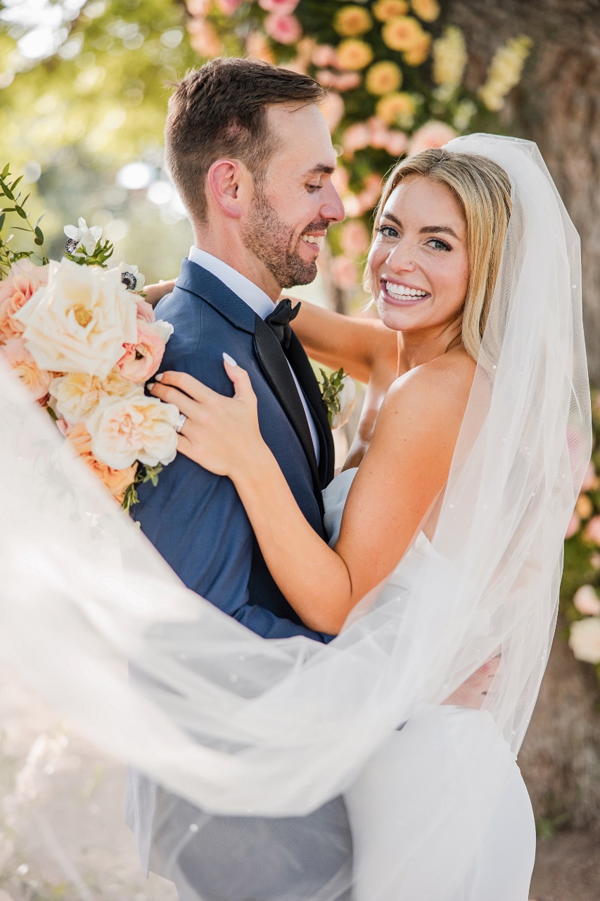 Sarah and Logan feeding cake at their Barr Mansion wedding