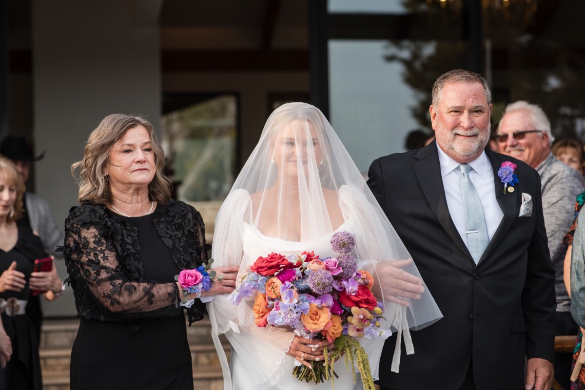Bride Cora looking in mirror during final wedding preparations