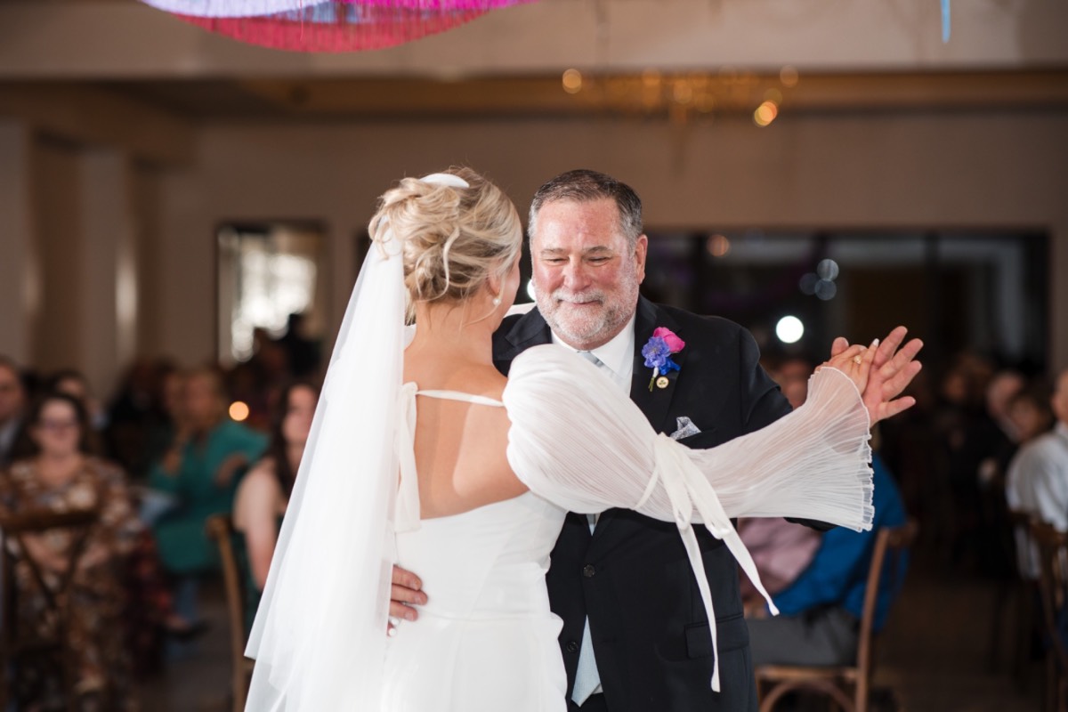 Bride and groom walking hand in hand at Wimberley venue