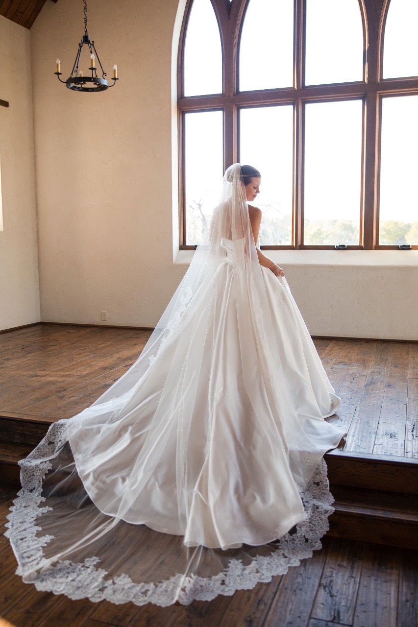 Hair and makeup artist styling bride's hair for Hidden River Ranch wedding