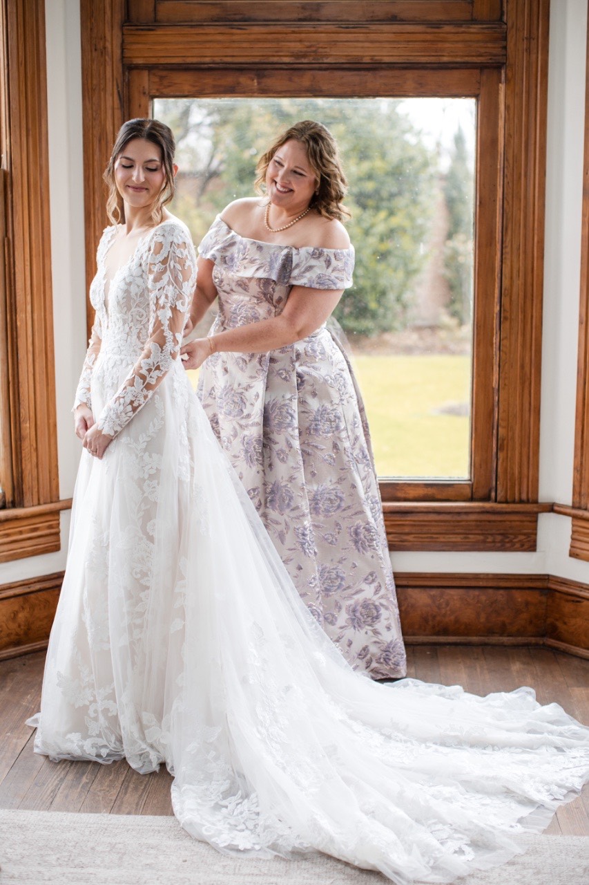 S and M getting ready for rainy wedding day at Barr Mansion Austin.