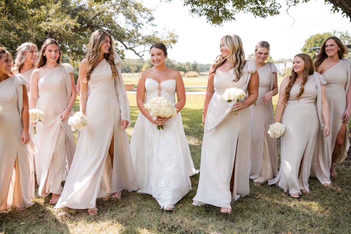 Darby walking down aisle toward Will during Pecan Springs Ranch ceremony