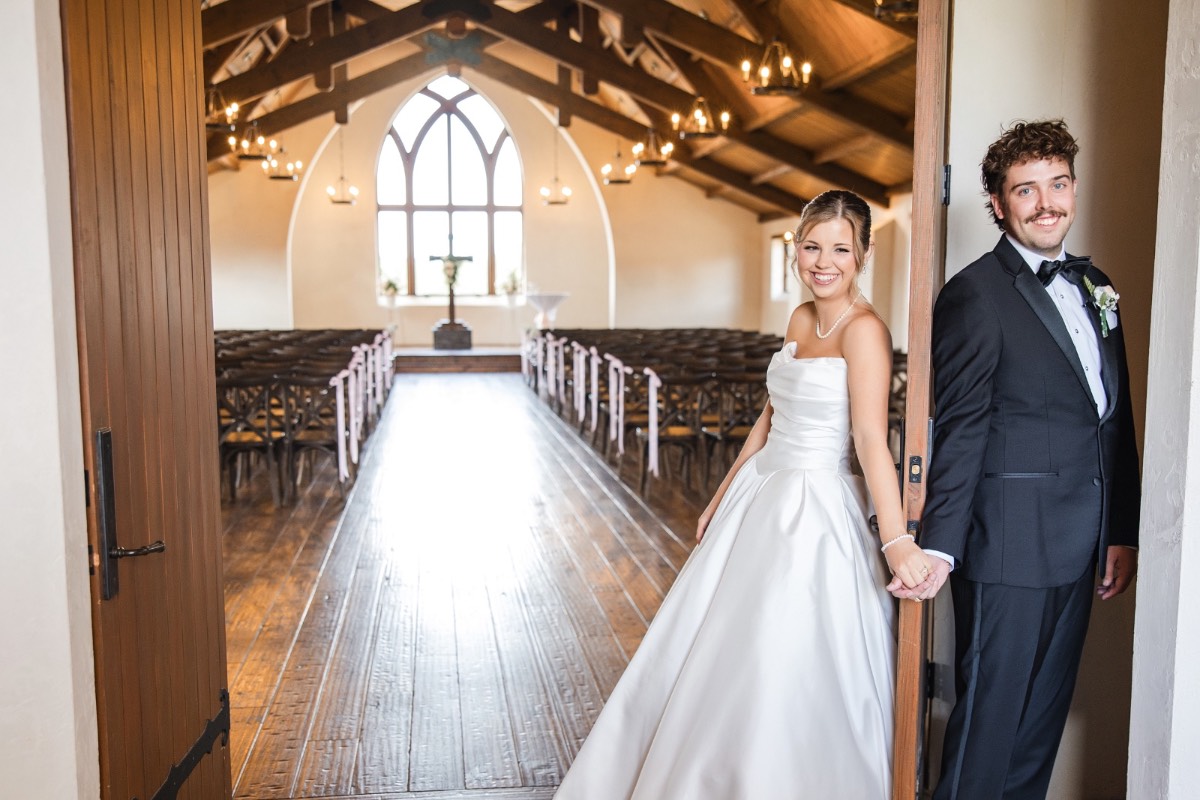 Groom watching bride walk down aisle at Hidden River Ranch Texas