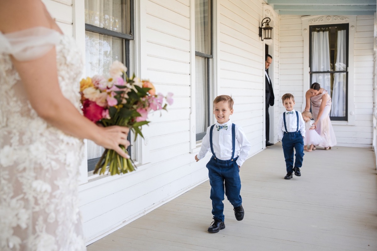 Bride L holding bouquet by Stem Floral before ceremony at Barr Mansion