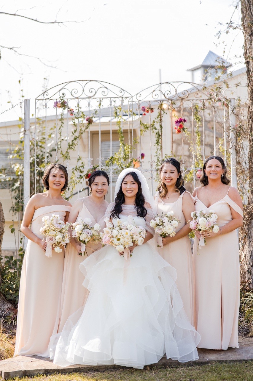 Pecan Springs Ranch ceremony with couple L and M exchanging vows outdoors
