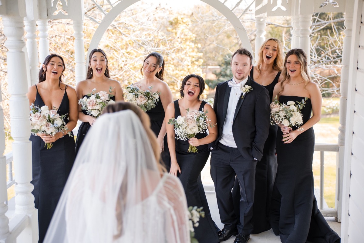 Groomsmen in formal attire outside historic Barr Mansion in Austin Texas.