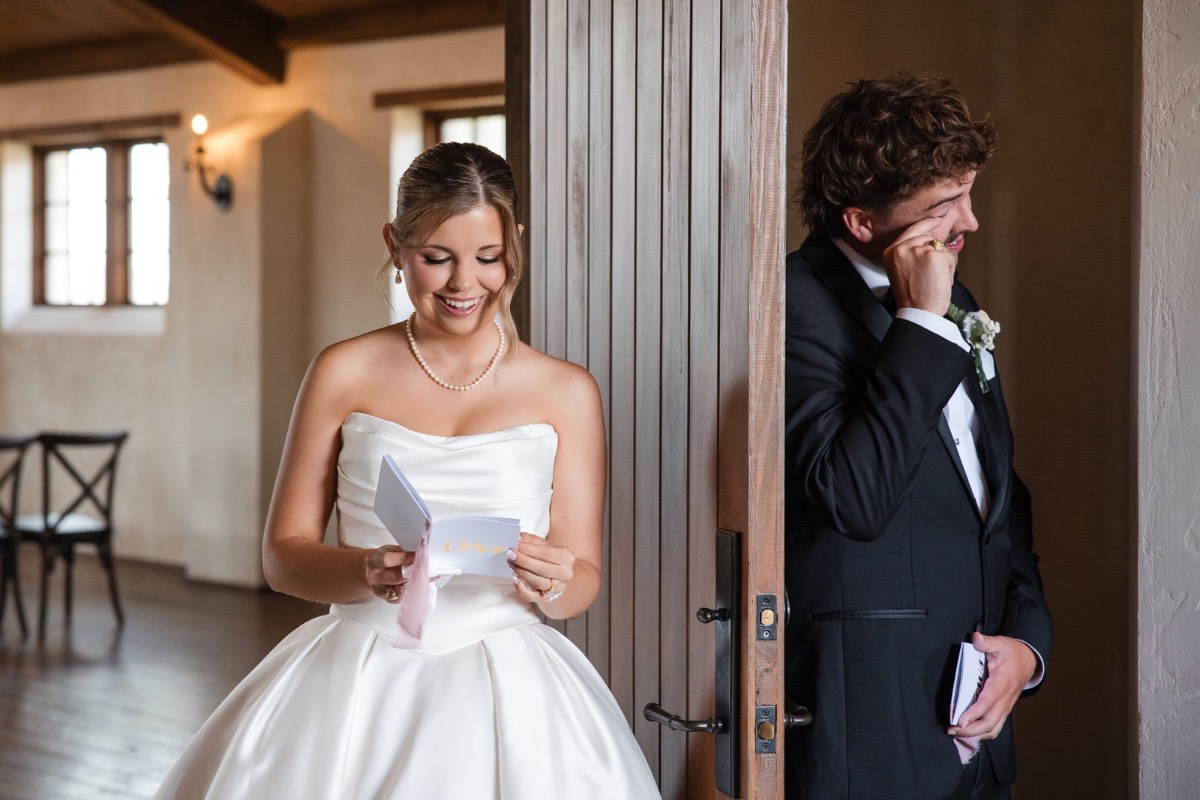 Bride and groom holding hands during emotional wedding ceremony exchange