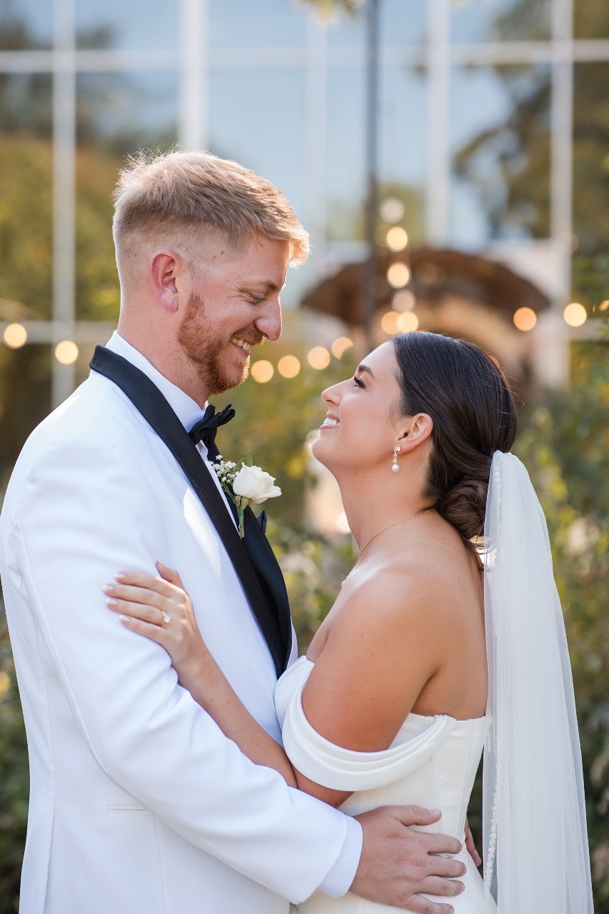 Bride and groom embracing after first look at Barr Mansion fall wedding