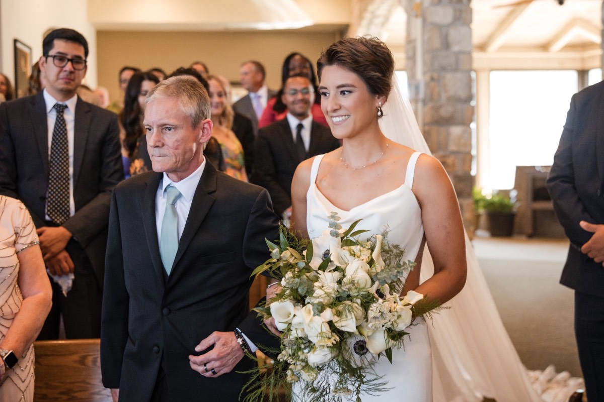 Bride walking toward groom for first look at The Retreat at Balcones Springs