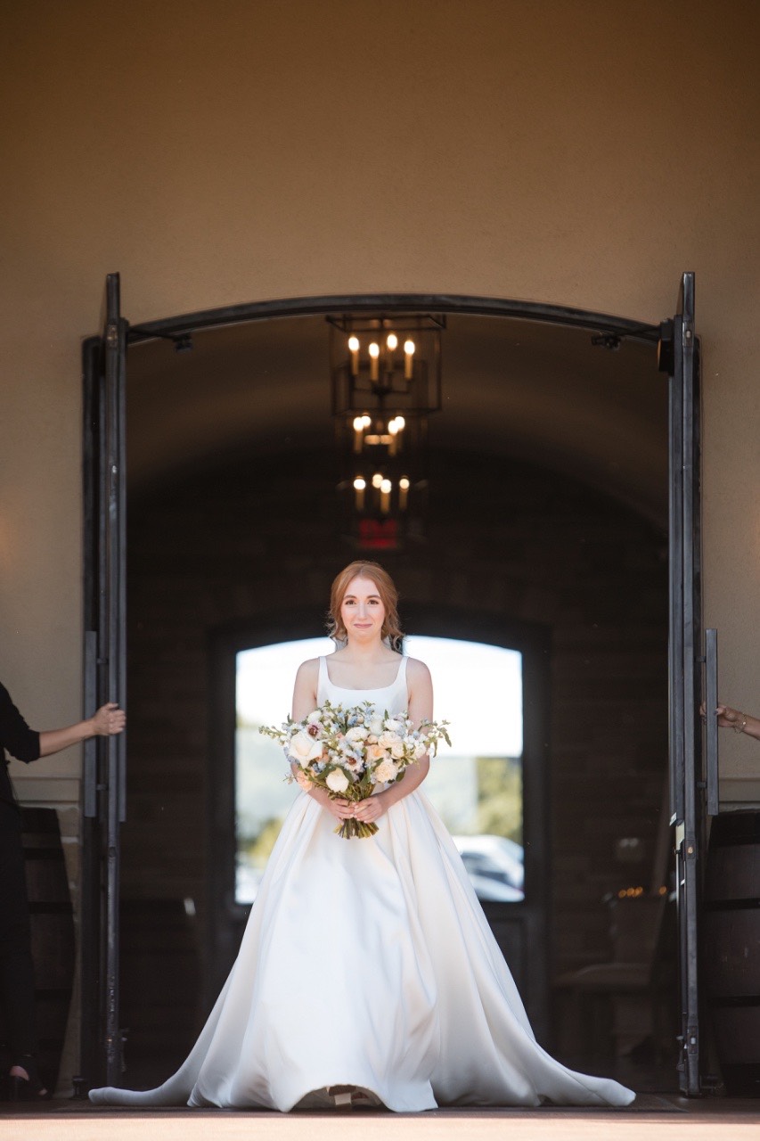 Groom and bride embrace during first look at Canyonwood Ridge outdoor wedding
