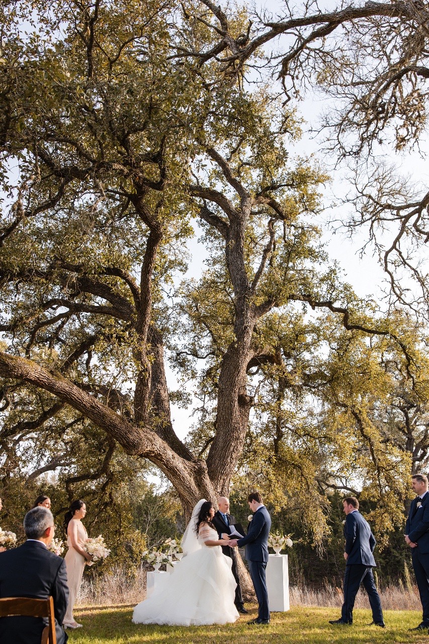 L and M walking back down aisle after ceremony at Pecan Springs Ranch