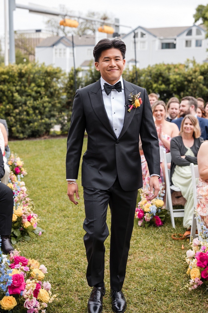 Bride walking toward groom for first look at Hotel Ella