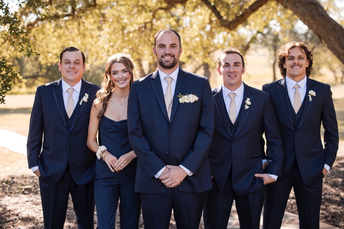 Groom kissing bride's forehead during emotional first look moment Dripping Springs