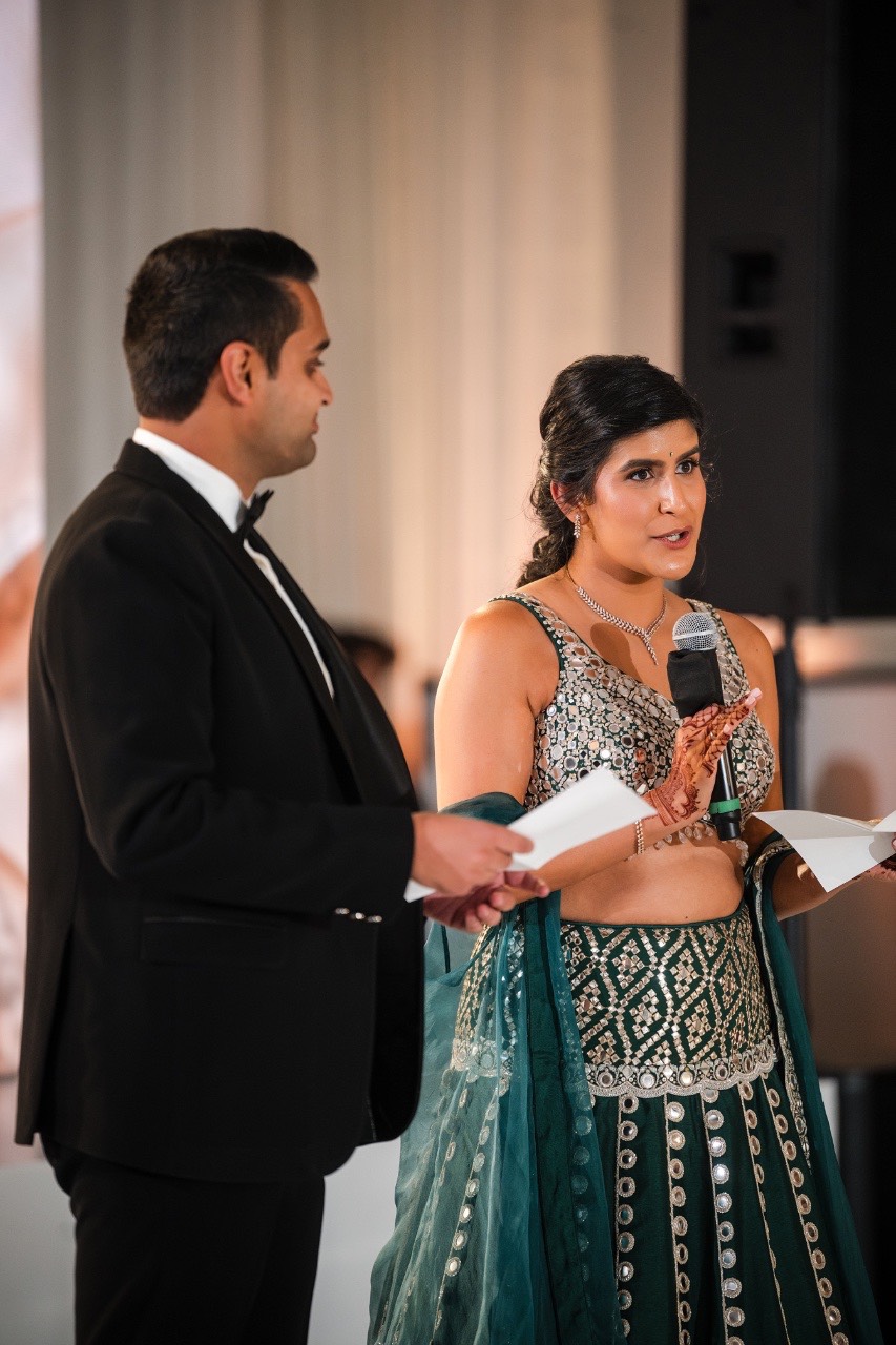 Bride R walking down aisle toward groom M at Renaissance Hotel Austin ceremony