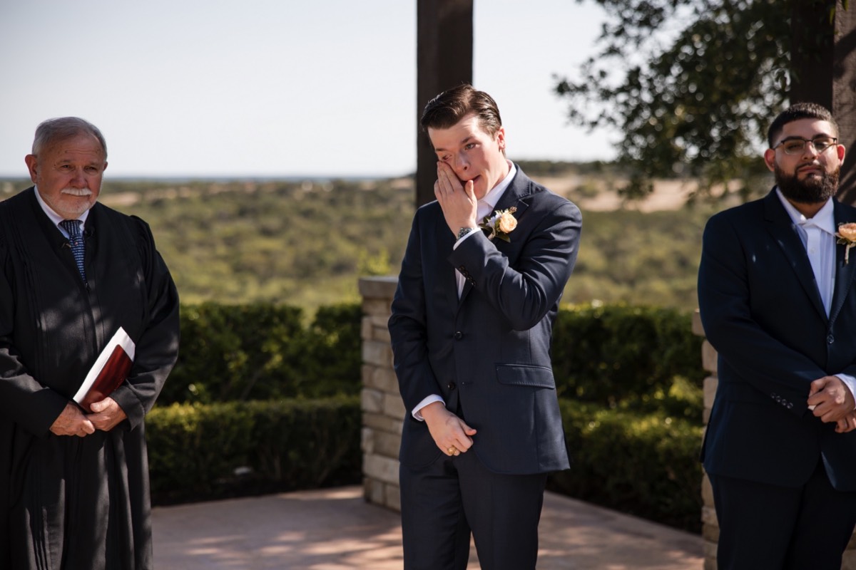 Canyonwood Ridge ceremony setup with elegant arch and wooden chairs in Dripping Springs