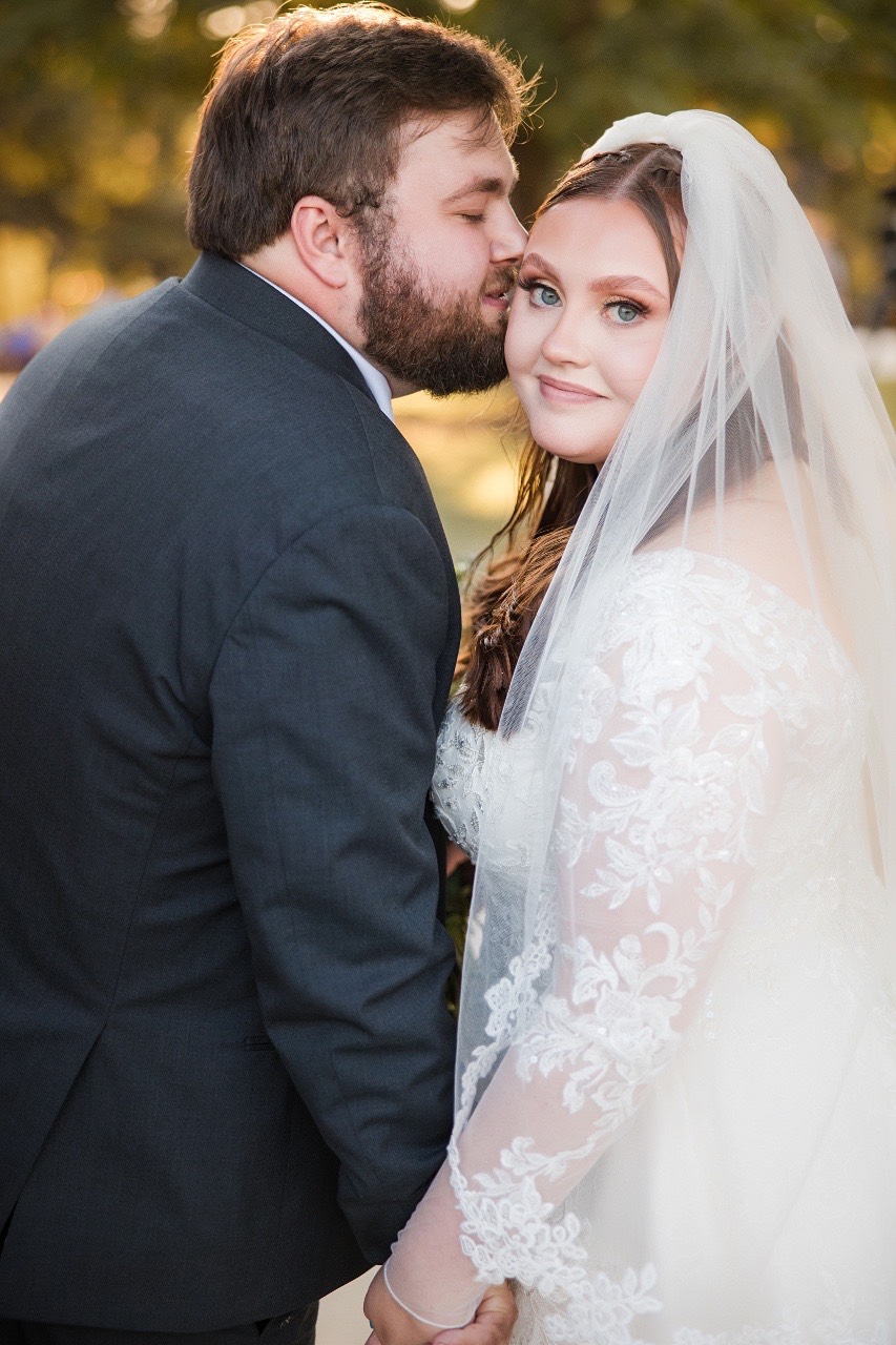Bride S and groom D first kiss as married couple at Old Glory Ranch