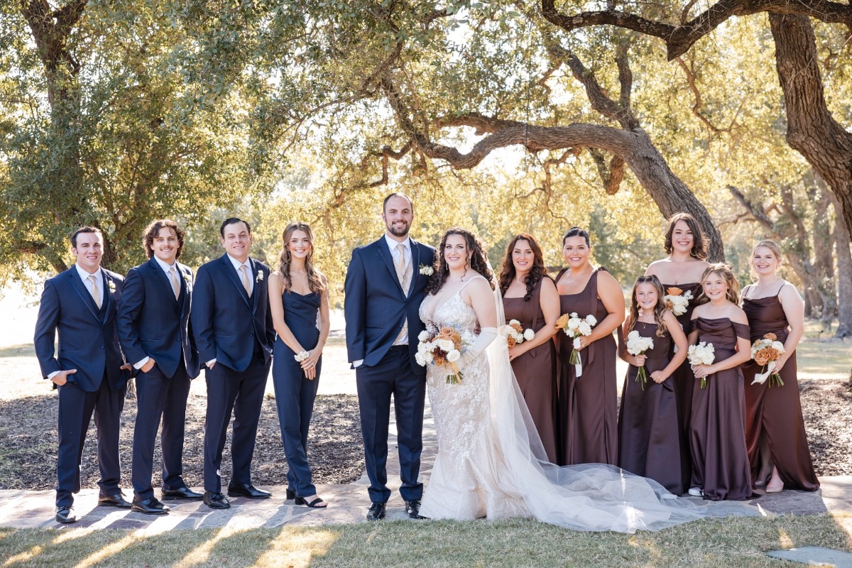 Outdoor ceremony setup with white chairs and arch at Ma Maison venue