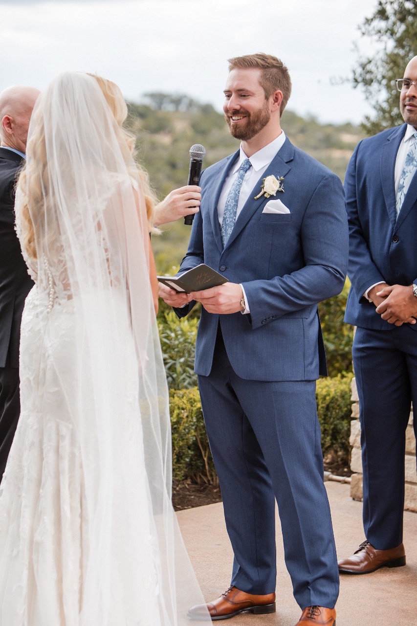 Close embrace during first look at Canyonwood Ridge Dripping Springs wedding