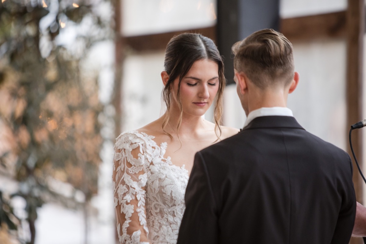 Bride and groom embracing after first look at Barr Mansion.