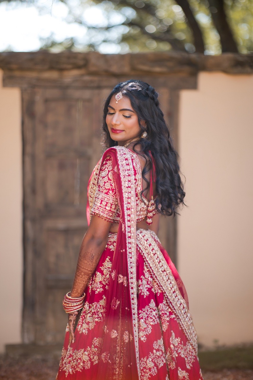 Bride Sreya walking down aisle at Spicewood ranch wedding ceremony