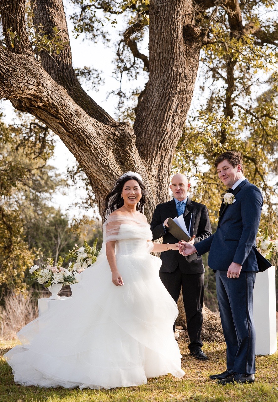 Bride and groom L and M with wedding party at Pecan Springs Ranch