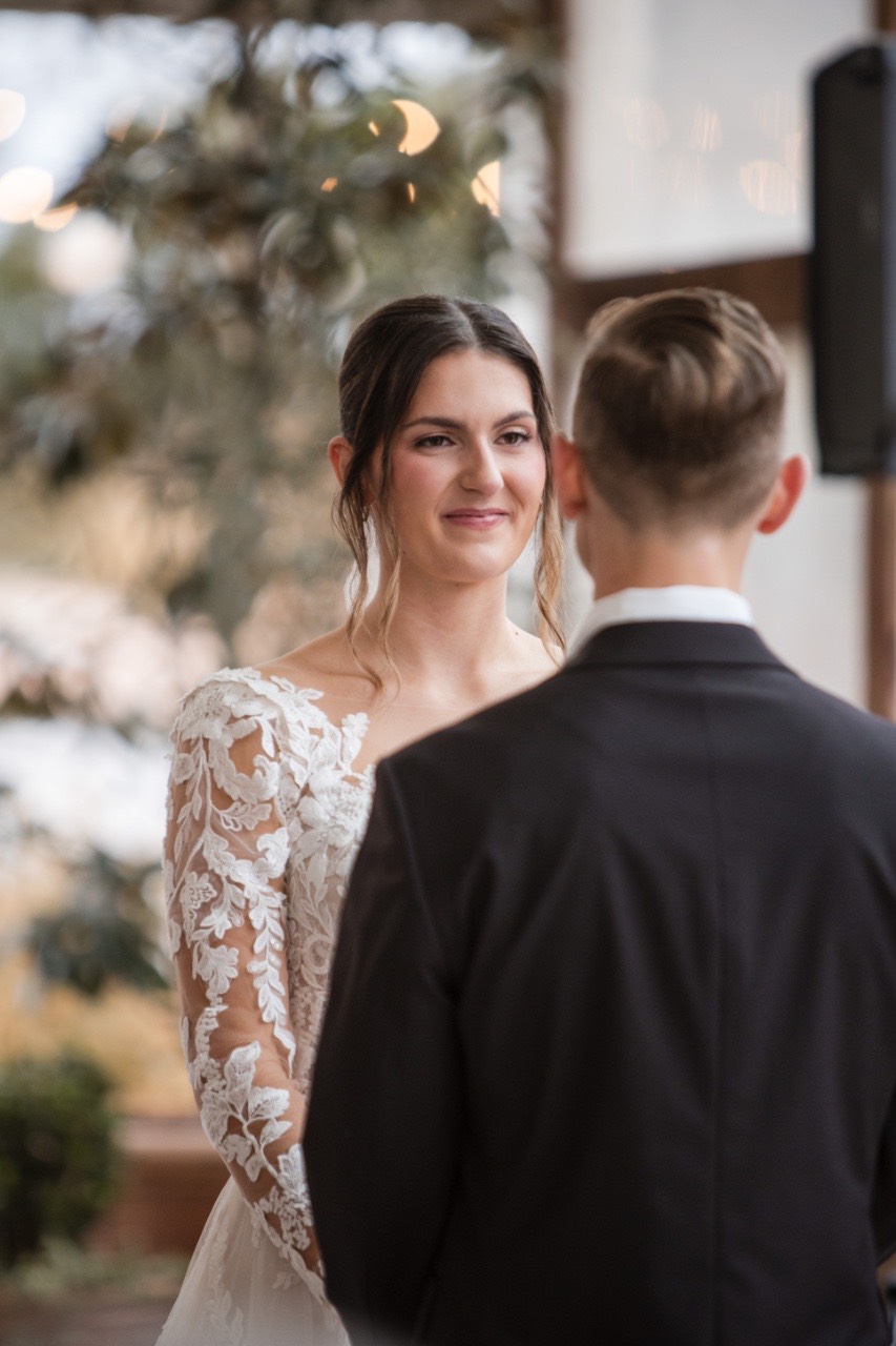 Romantic first look moment captured during rainy wedding day.