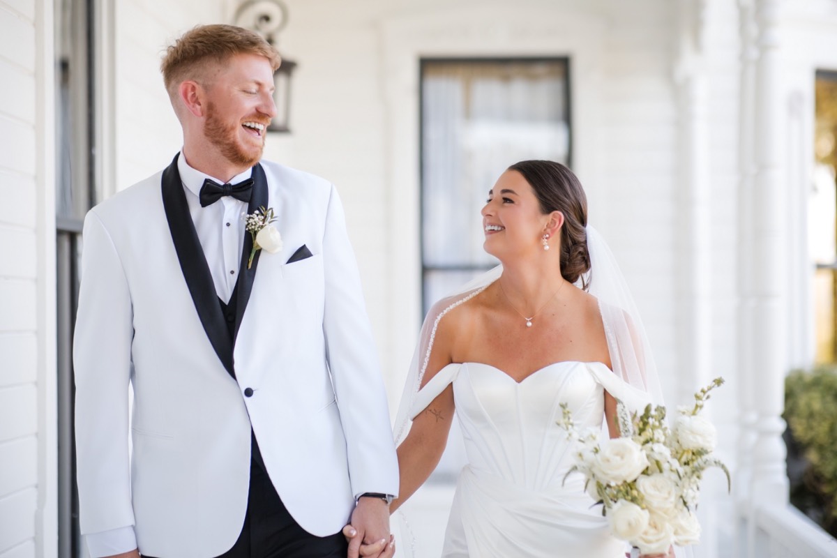 Couple walking together after first look at Barr Mansion fall wedding venue