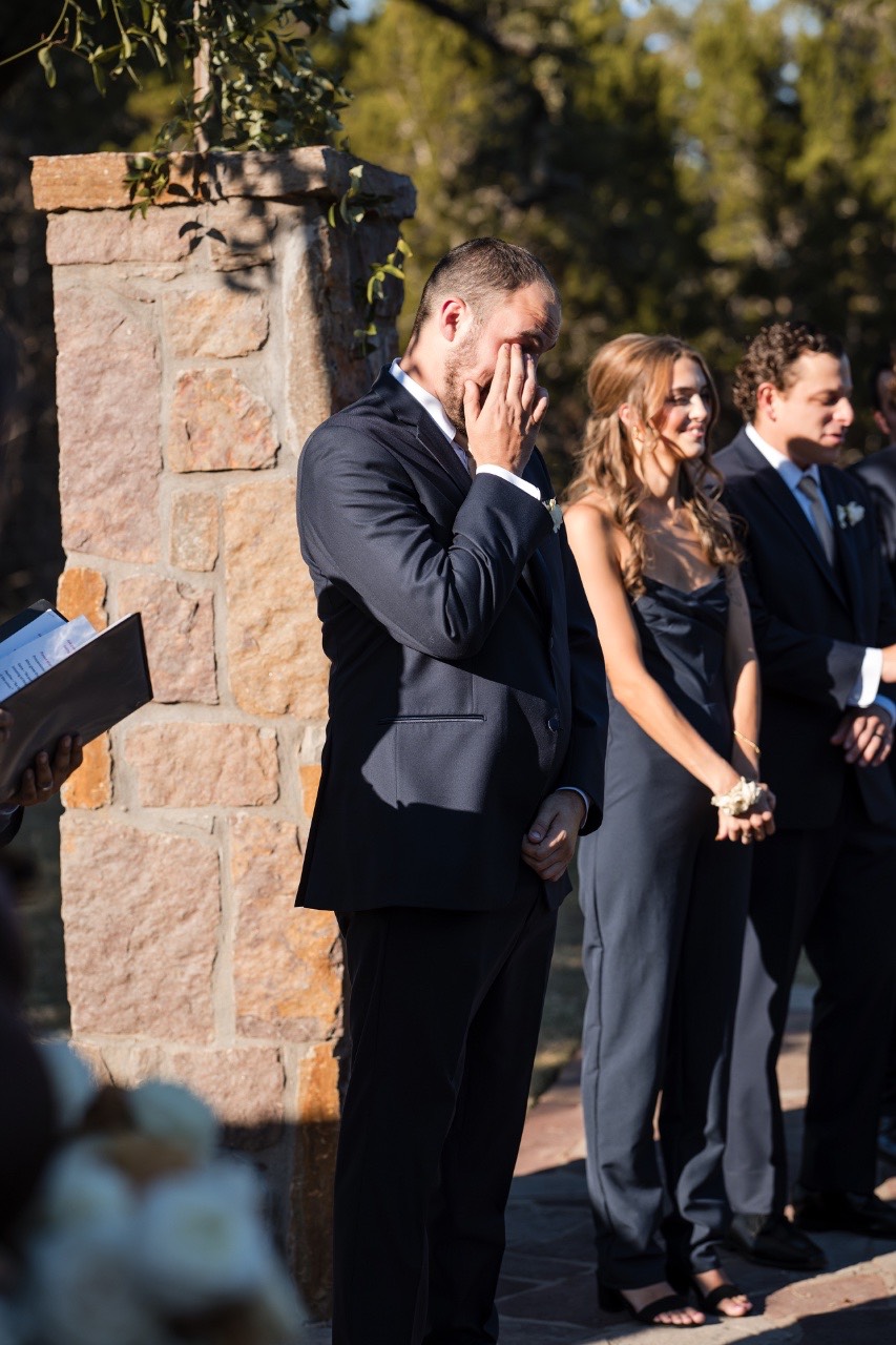 Bride walking down aisle toward groom at Ma Maison Dripping Springs Texas