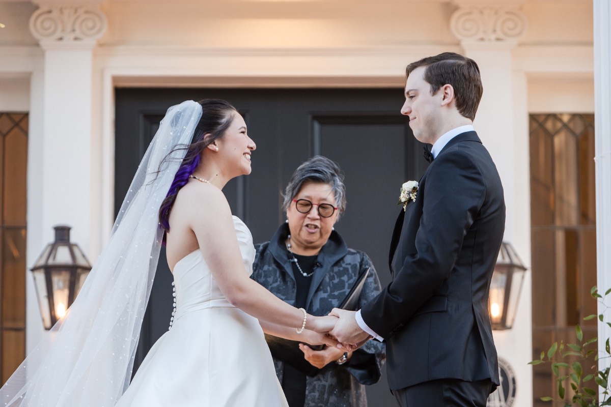 Bride and groom exchanging vows at Woodbine Mansion wedding