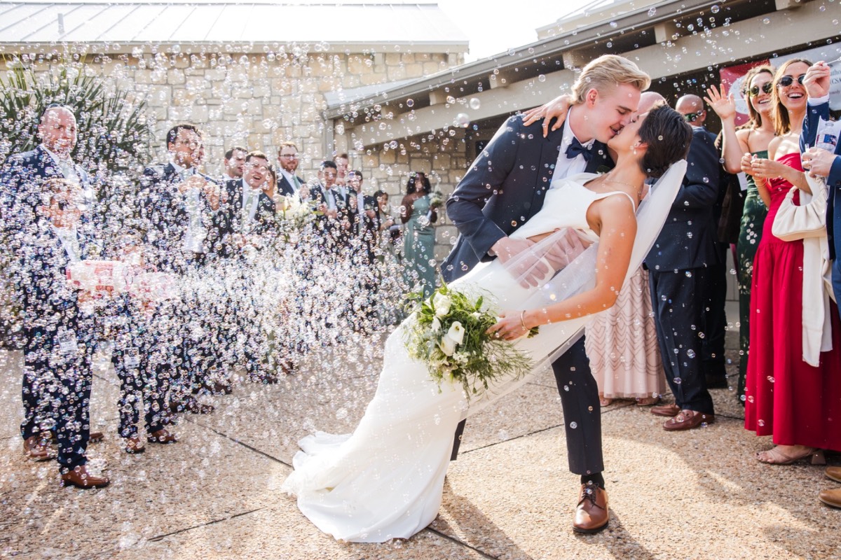 Bride and groom holding hands during vows at The Retreat at Balcones Springs