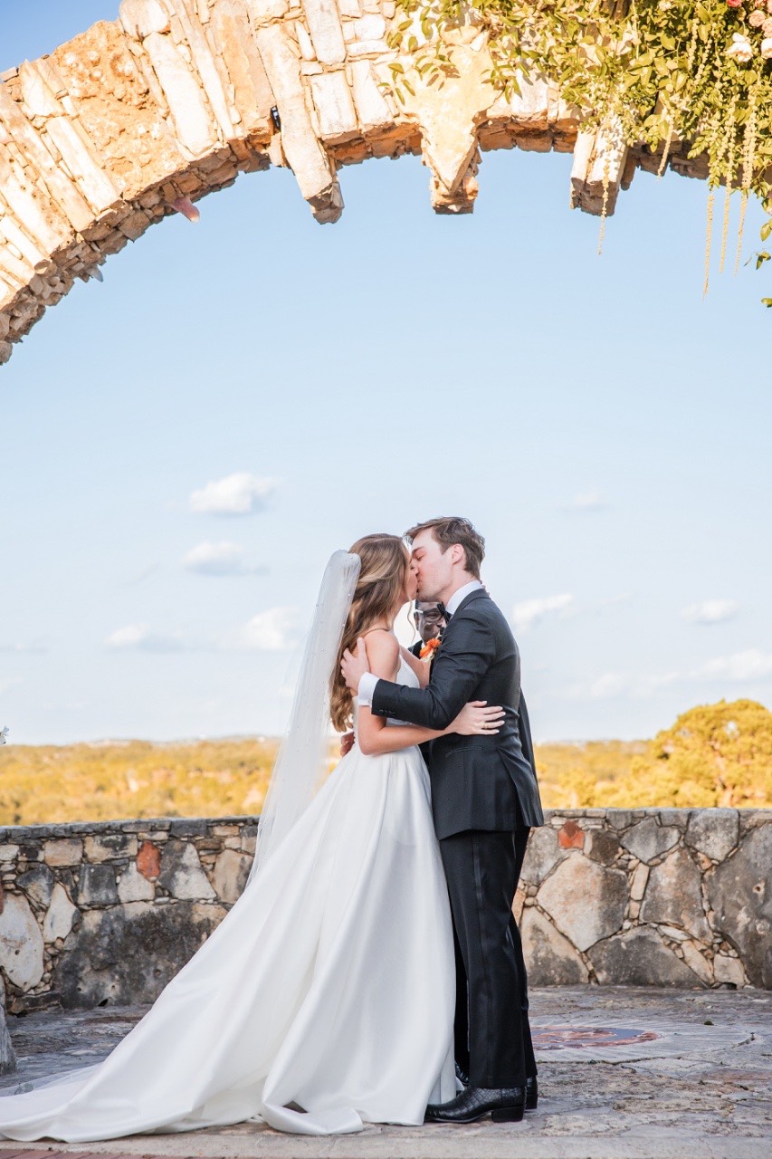 Bride and groom laughing during candid portraits at Camp Lucy venue