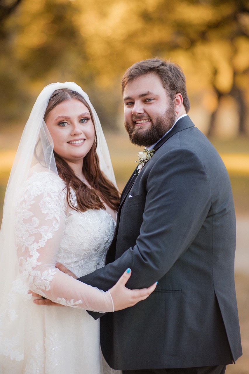 Wedding party celebrating S and D outside Old Glory Ranch barn in Wimberley