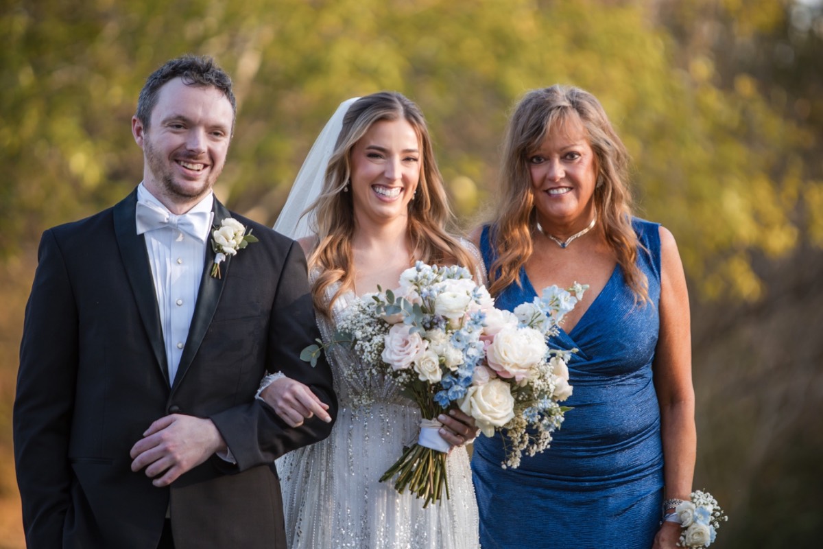 A kissing S's hand during first look in Austin winter wedding.