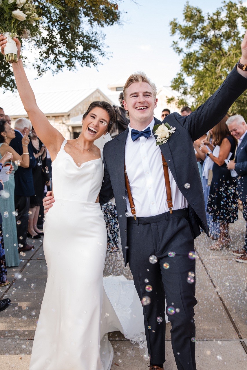 Ceremony kiss between K and N at Balcones Springs wedding in Marble Falls