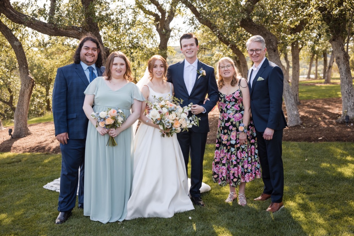 Bride and groom kiss during ceremony at scenic Canyonwood Ridge wedding venue