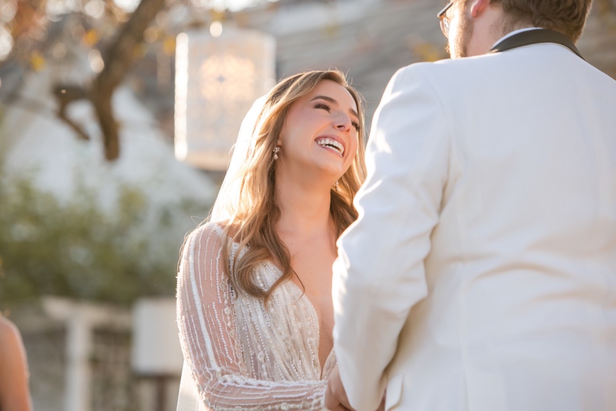 S walking down aisle in white gown at Barr Mansion ceremony.