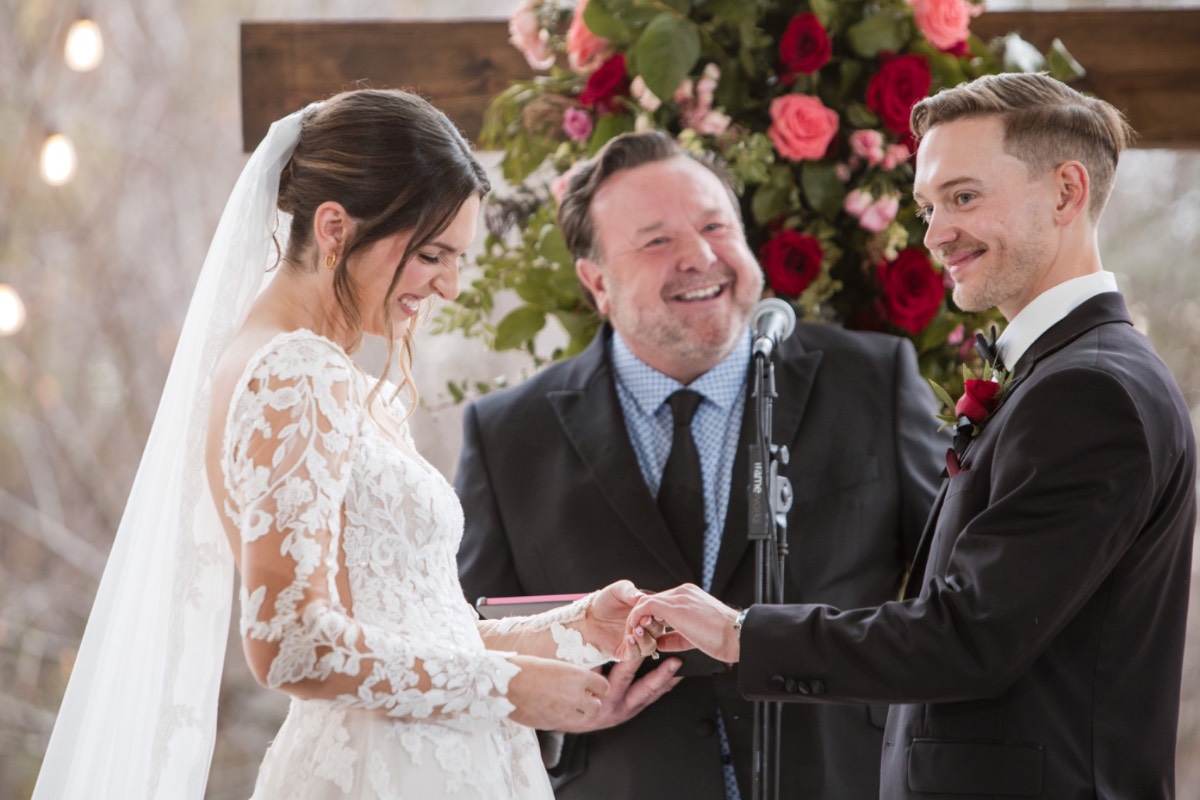 Bride and groom holding hands during first look interaction.