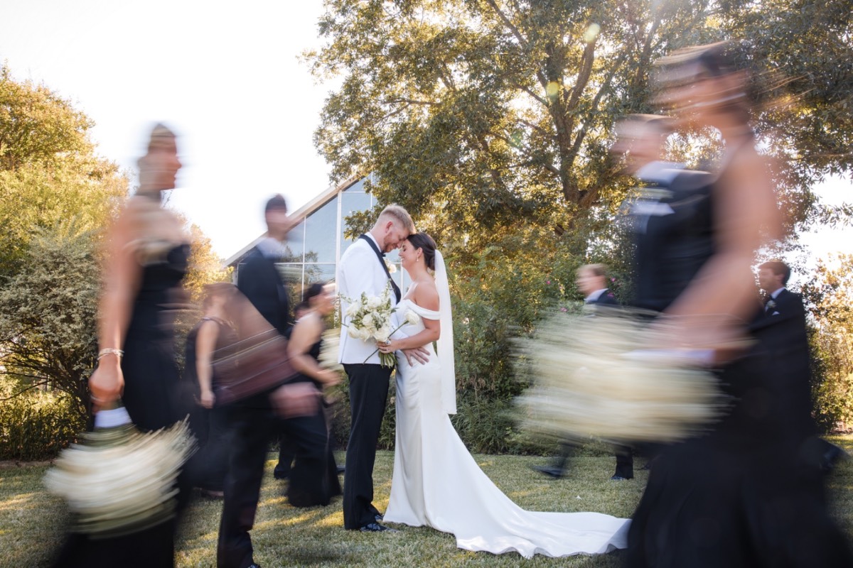 Floral arrangements by Poppy Flowers adorning ceremony aisle at Austin Barr Mansion wedding