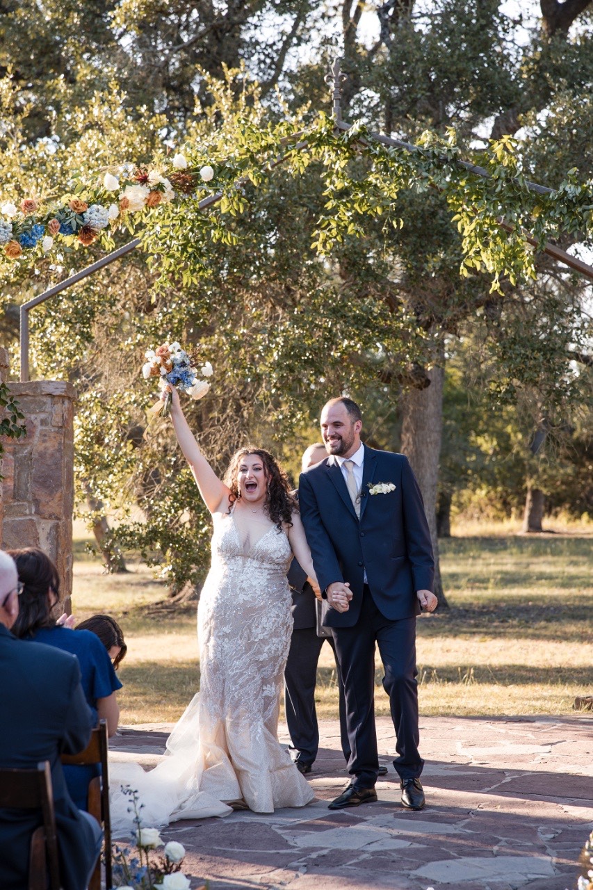 Bride and groom's first kiss as married couple at Dripping Springs venue