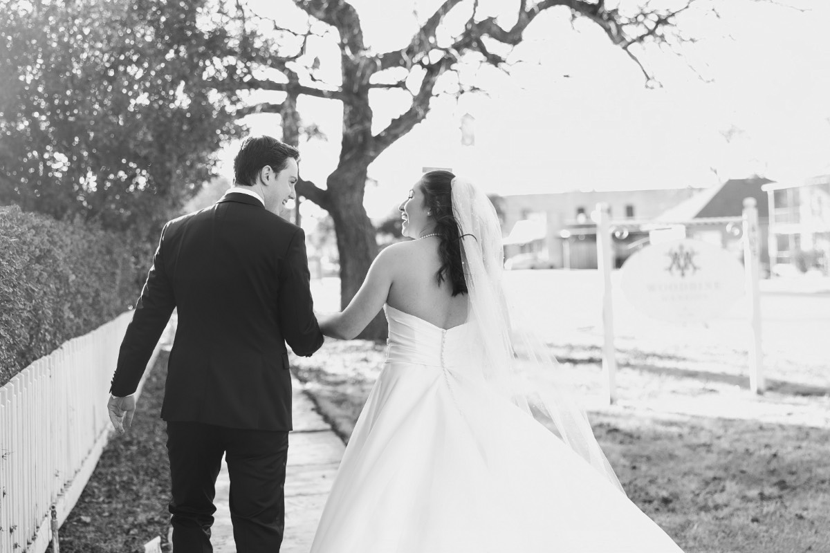 Groom sliding ring onto bride's finger at Woodbine Mansion ceremony