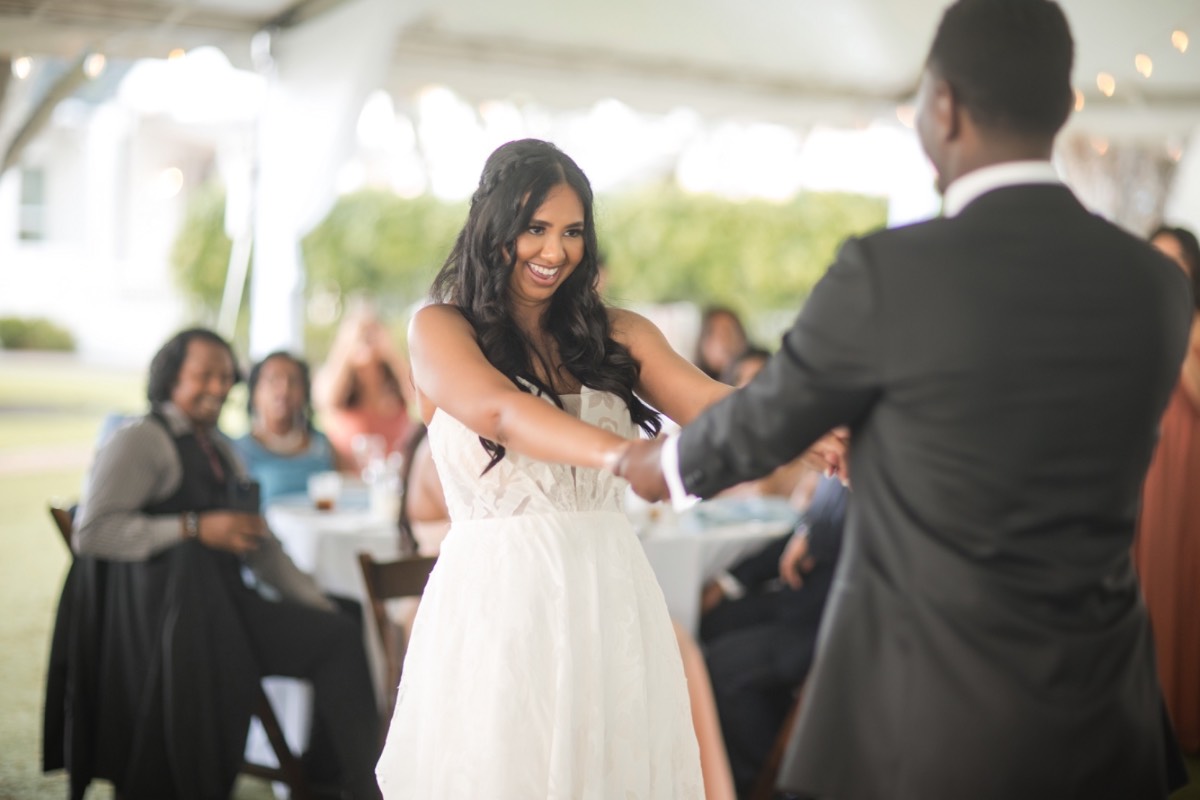 H watching N walk down aisle at Woodbine Mansion Texas