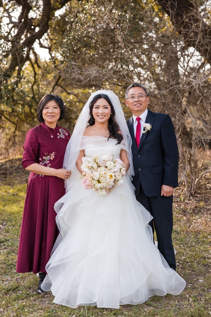 Family portrait of couple L and M with parents at Pecan Springs Ranch