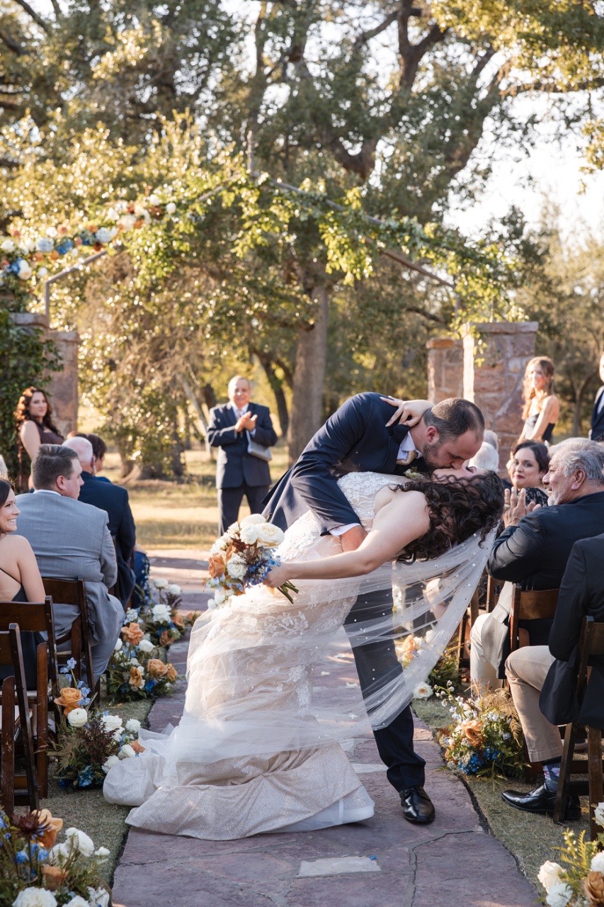 Officiant blessing C and C during Ma Maison fall wedding ceremony