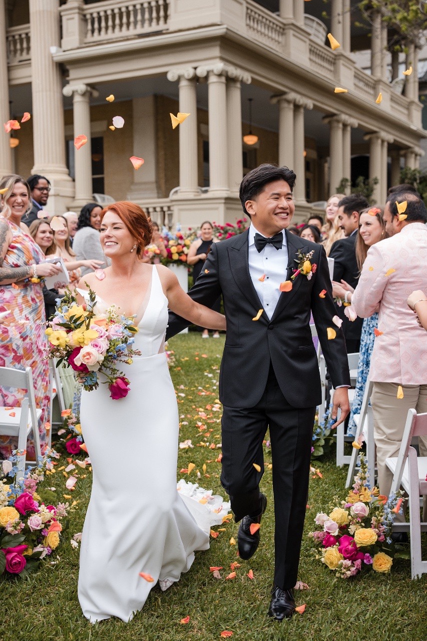Bride and groom holding hands during Hotel Ella wedding ceremony