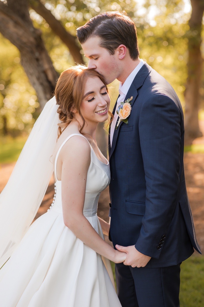 Officiant and couple during Canyonwood Ridge outdoor wedding ceremony in Dripping Springs